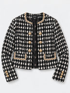CÈGLÈ luxury tweed blazer in a black and white houndstooth pattern, featuring gold-tone buttons and matching gold chain pearl trim along the collar, pocket edges, and cuffs. CÈGLÈ monogram lining.